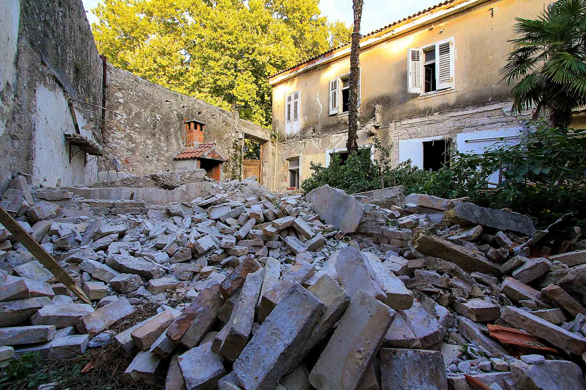 The extensive courtyard cleaning works start at the future Almayer Hotel's secret garden in Zadar, Croatia, with a pile of rubble in front.