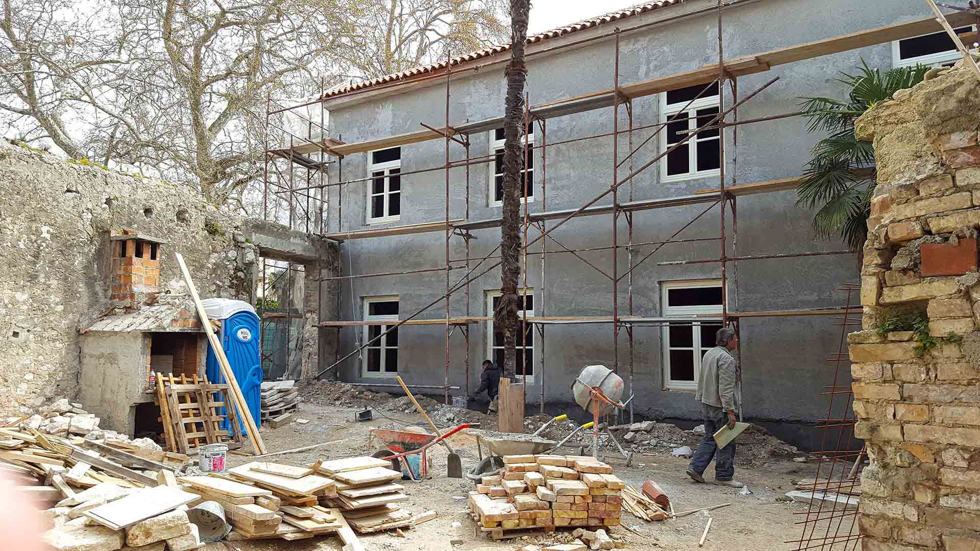 A view of the freshly plastered facade of the future Almayer Hotel during its 2016 reconstruction