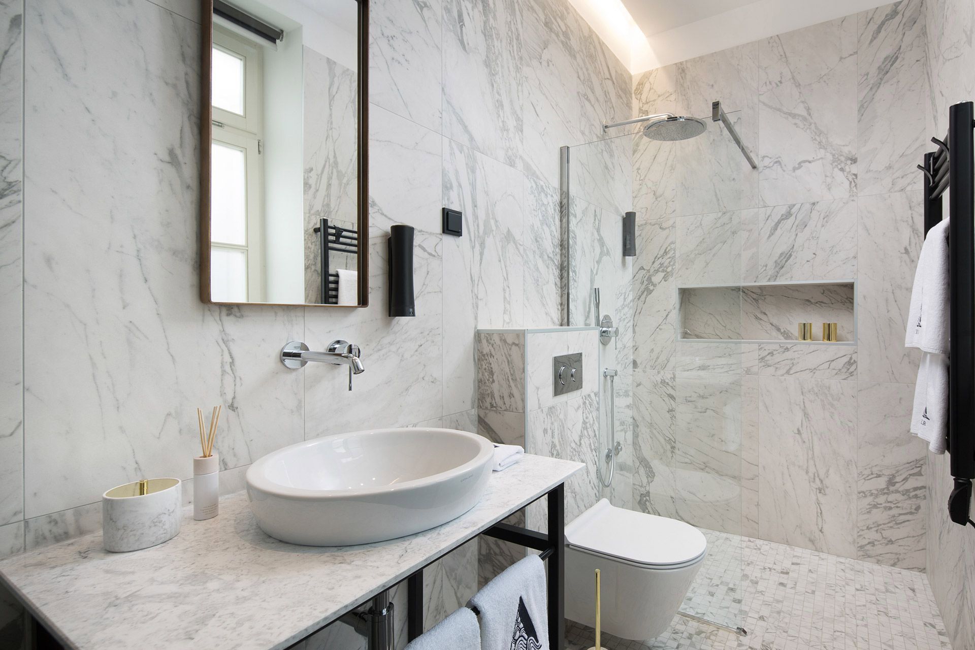 Bright and elegant marble tiles bathroom interior design of the Almayer hotel’s standard double room Garbin