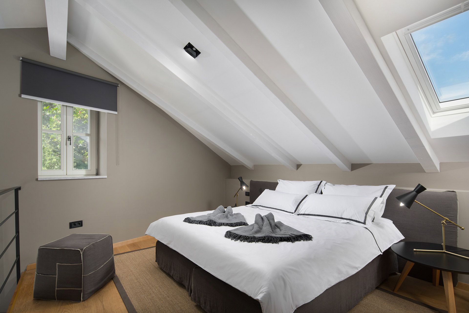Lofty mezzanine sleeping area in Almayer hotel’s Deluxe Double Room with a comfortable king-size bed