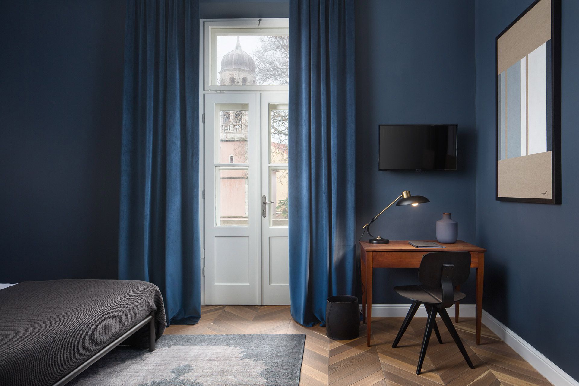 Almayer Dependance: Superior Double Room 'Burato' with elegant interior, featuring a comfortable queen-size bed, a functional desk, a balcony door, and a breathtaking city view